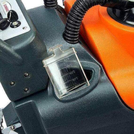 Industrial walk-behind floor scrubber in warehouse